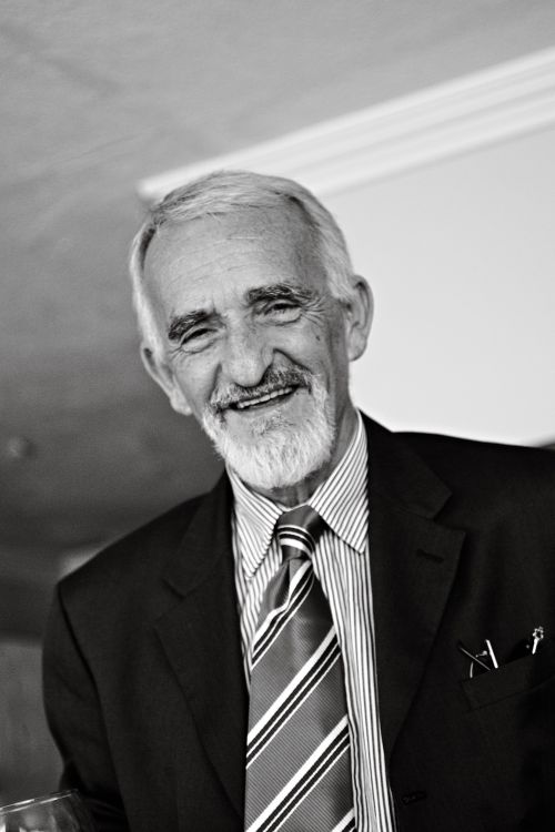 Free Elegant black and white portrait of a senior man in a suit, exuding charm and wisdom. Stock Photo