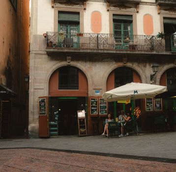A quaint European cafe with outdoor seating in a historic city square, ideal for travel and lifestyle.
