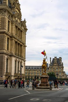 Louvre Museum with equestrian statue and vibrant street scene in Paris.