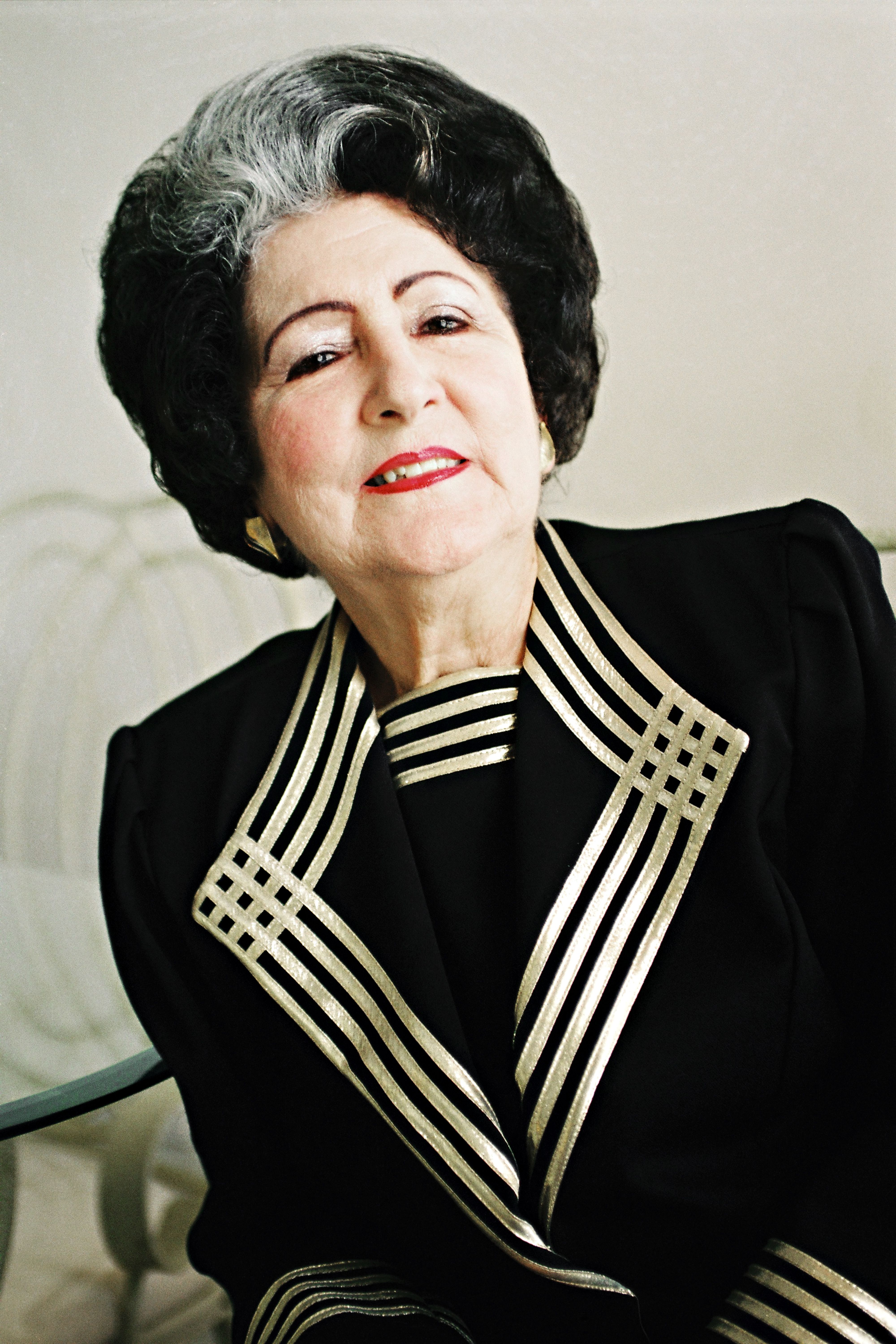 Charming senior woman in vintage attire, exuding elegance and confidence.