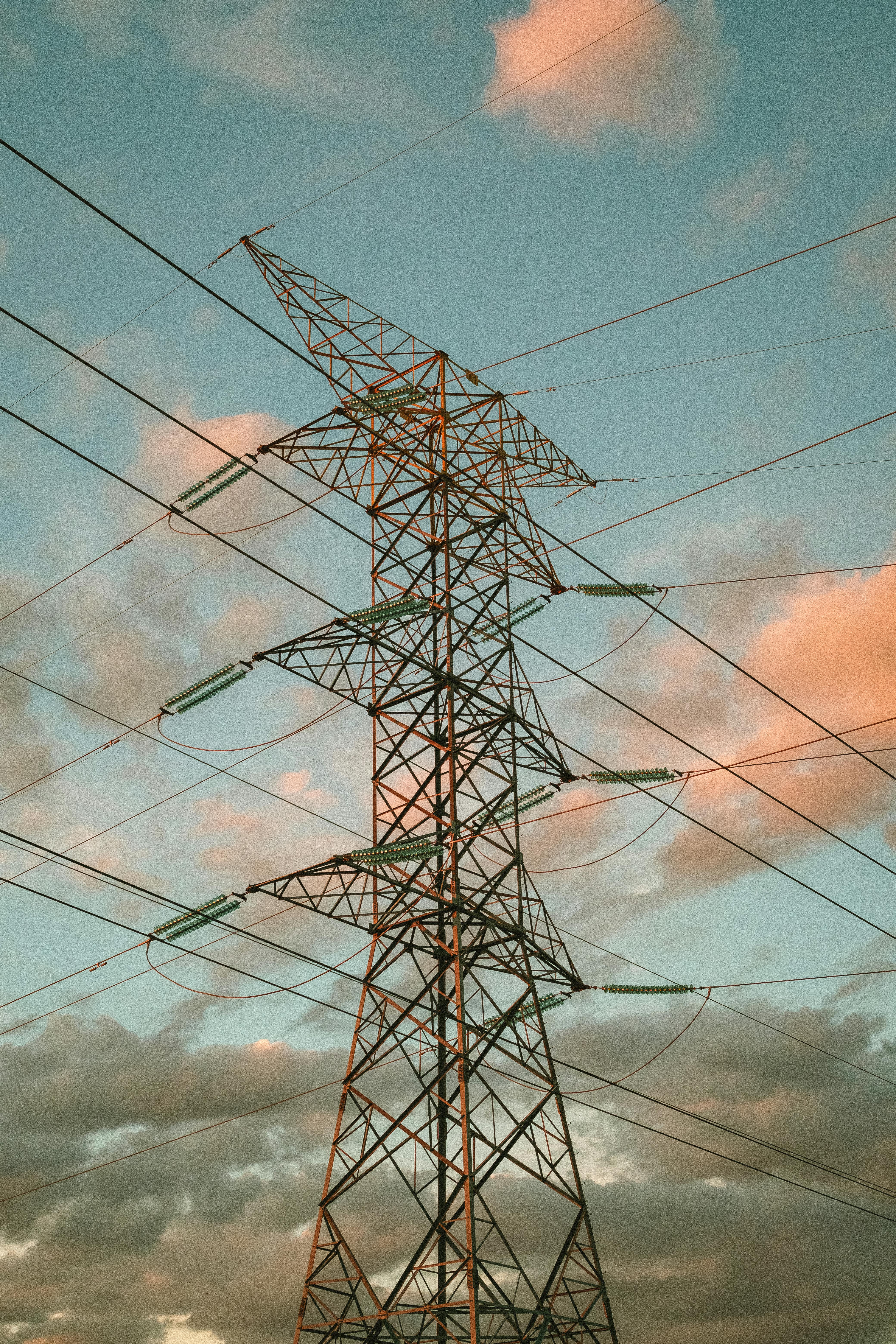 A towering power line against a colorful sky in Aguascalientes, Mexico captures the industrial landscape.