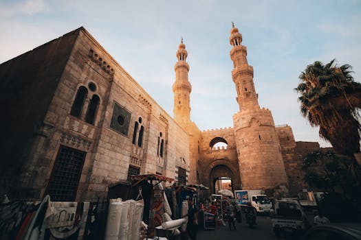 A bustling scene at Bab Zuweila in historic Cairo featuring Islamic architecture and vibrant market life.