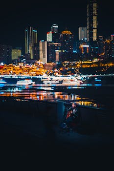 Street musician playing at night with a stunning city skyline in the background.