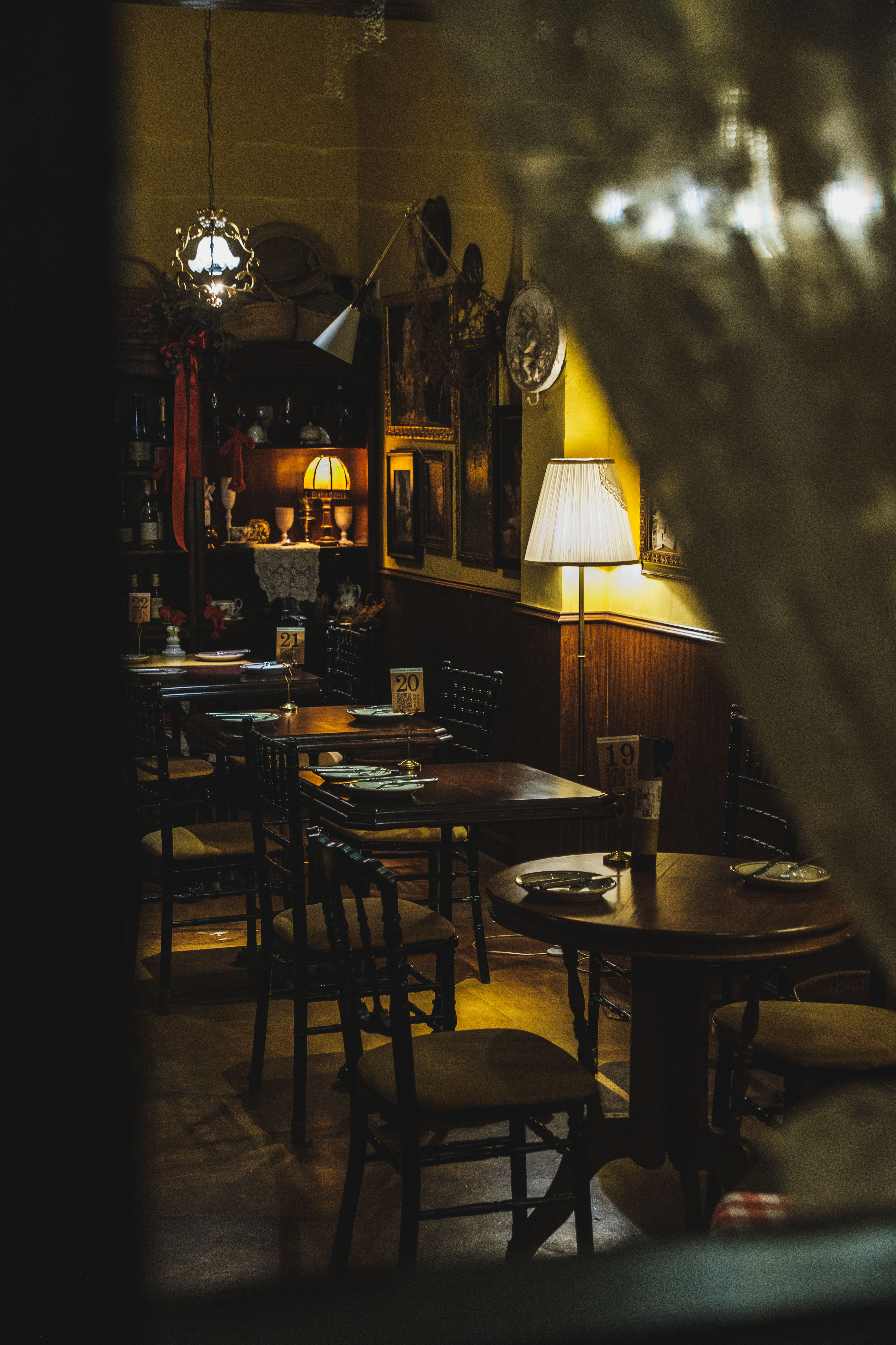 Explore a quaint dining setting with vintage decor and warm ambient lighting for a perfect evening experience.