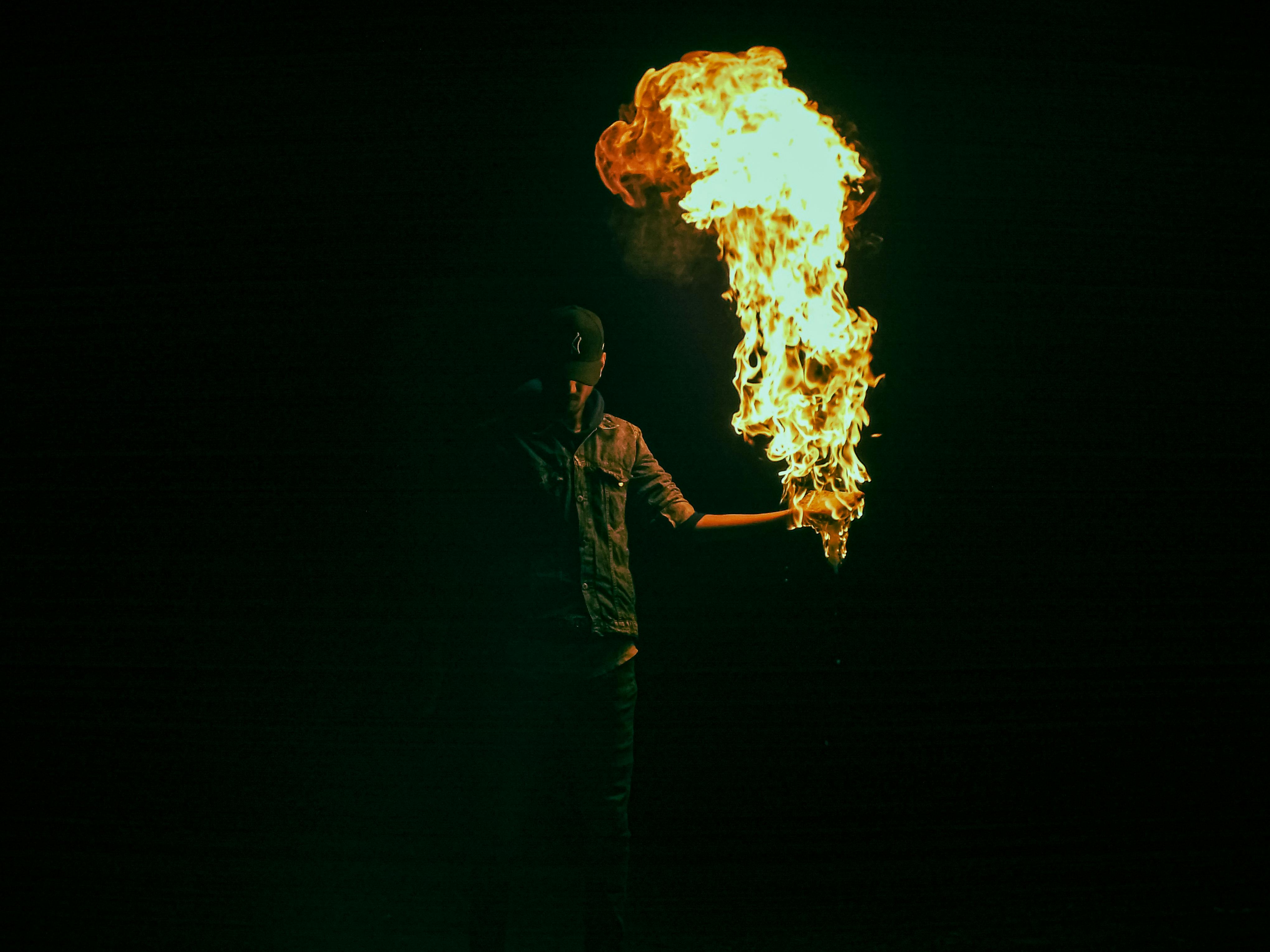 Captivating image of a fire performer in the dark, creating a mesmerizing display.