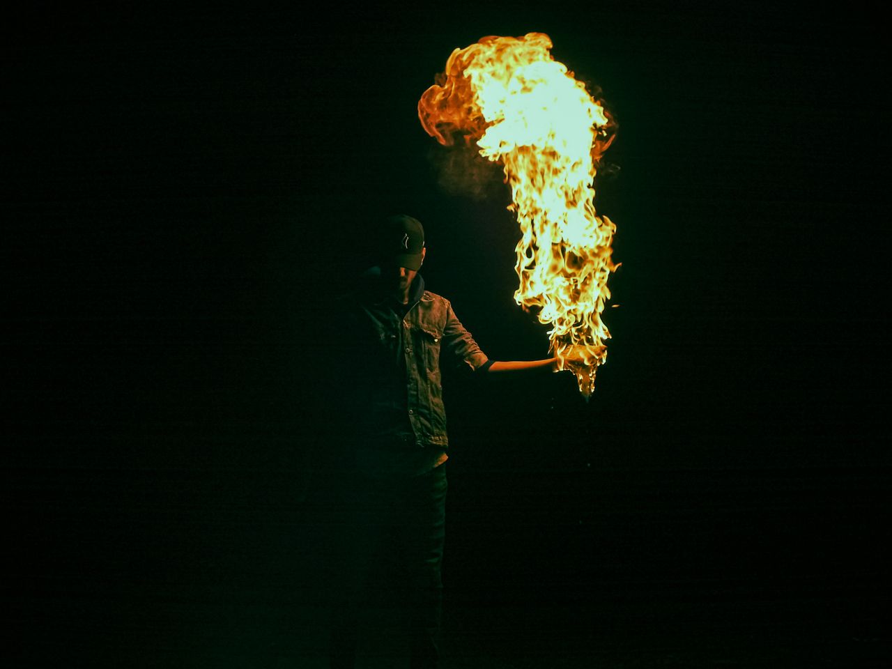 captivating image of a fire performer in the dark creating a mesmerizi