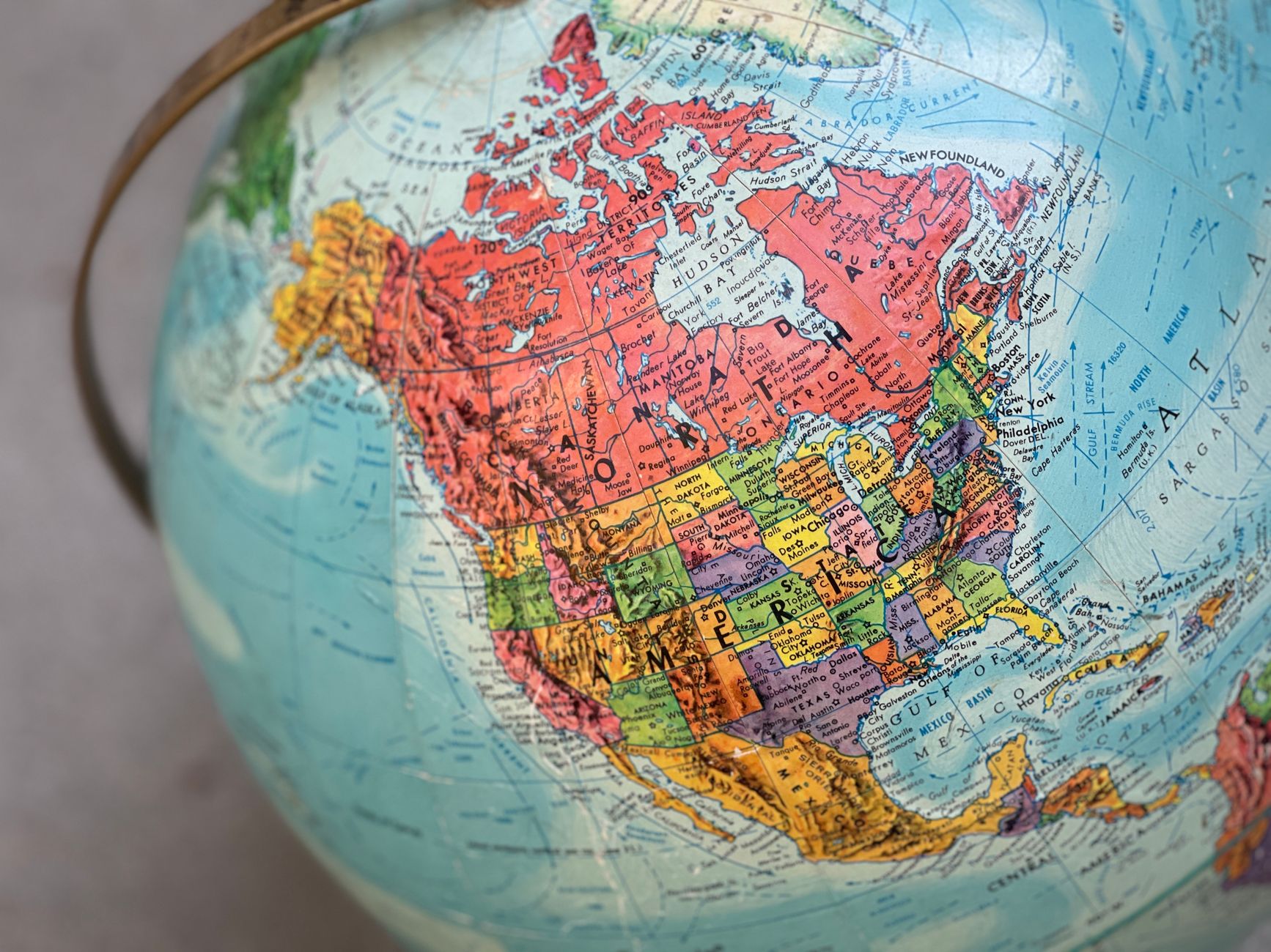 Detailed close-up of a vintage globe highlighting North America with vivid colors.