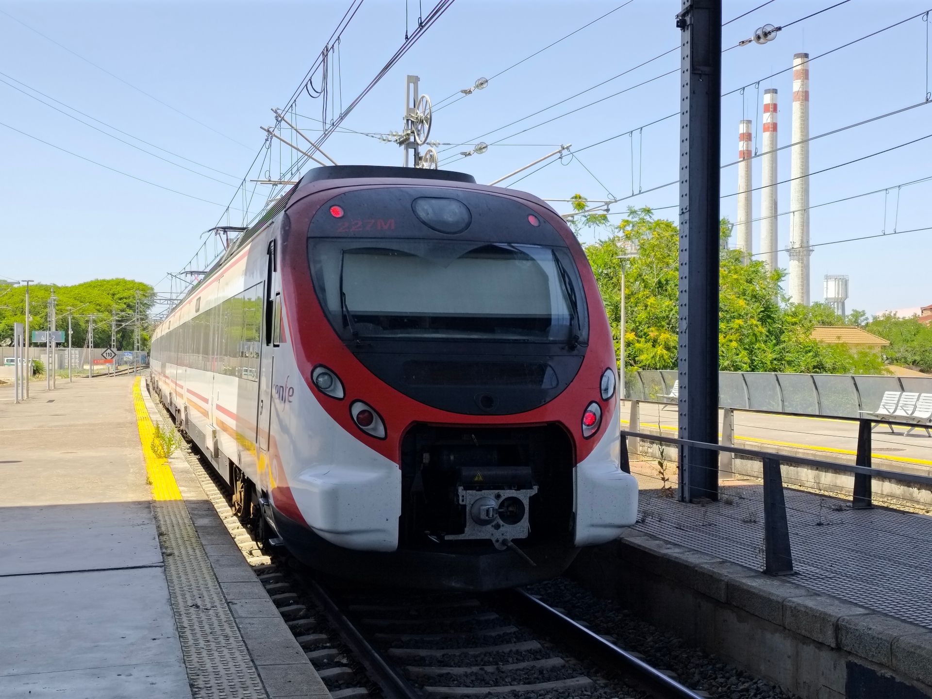 Passenger train at a railway station in Cadiz, Spain on a sunny day.