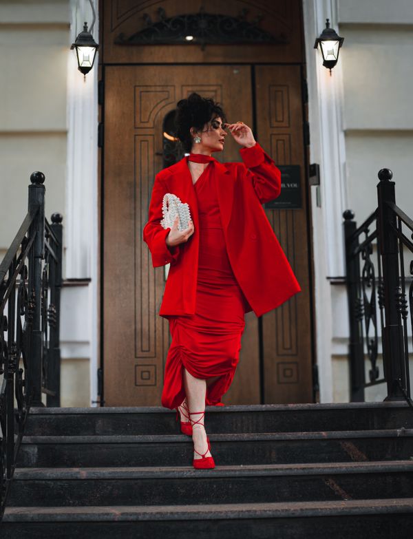 Woman in a red slip dress with blazer for date night