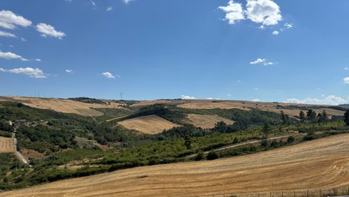 Free Peaceful rural view of rolling hills under a clear blue sky. Stock Photo