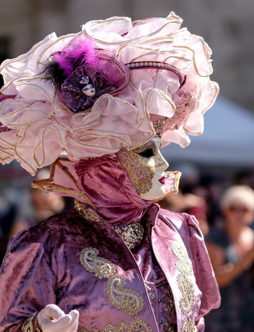 Free Close-up of a vibrant masquerade costume with ornate decorations at a Venetian carnival. Stock Photo
