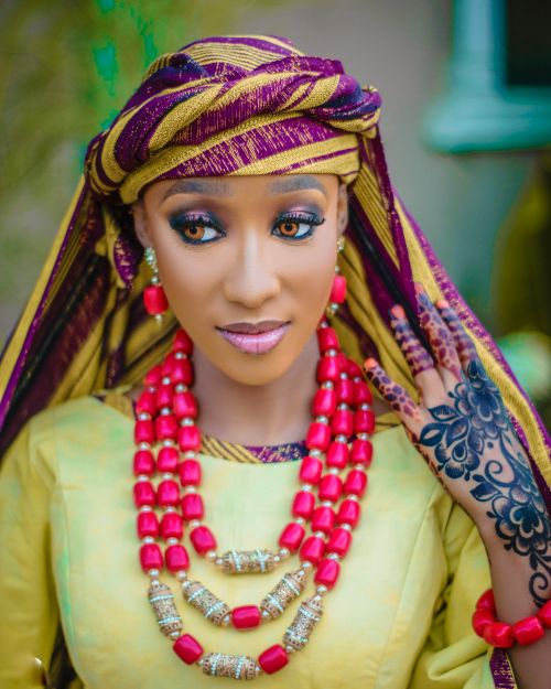 Free Woman in colorful traditional attire and henna art displaying cultural beauty. Stock Photo