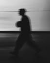 Silhouette of Person Walking with Motion Blur