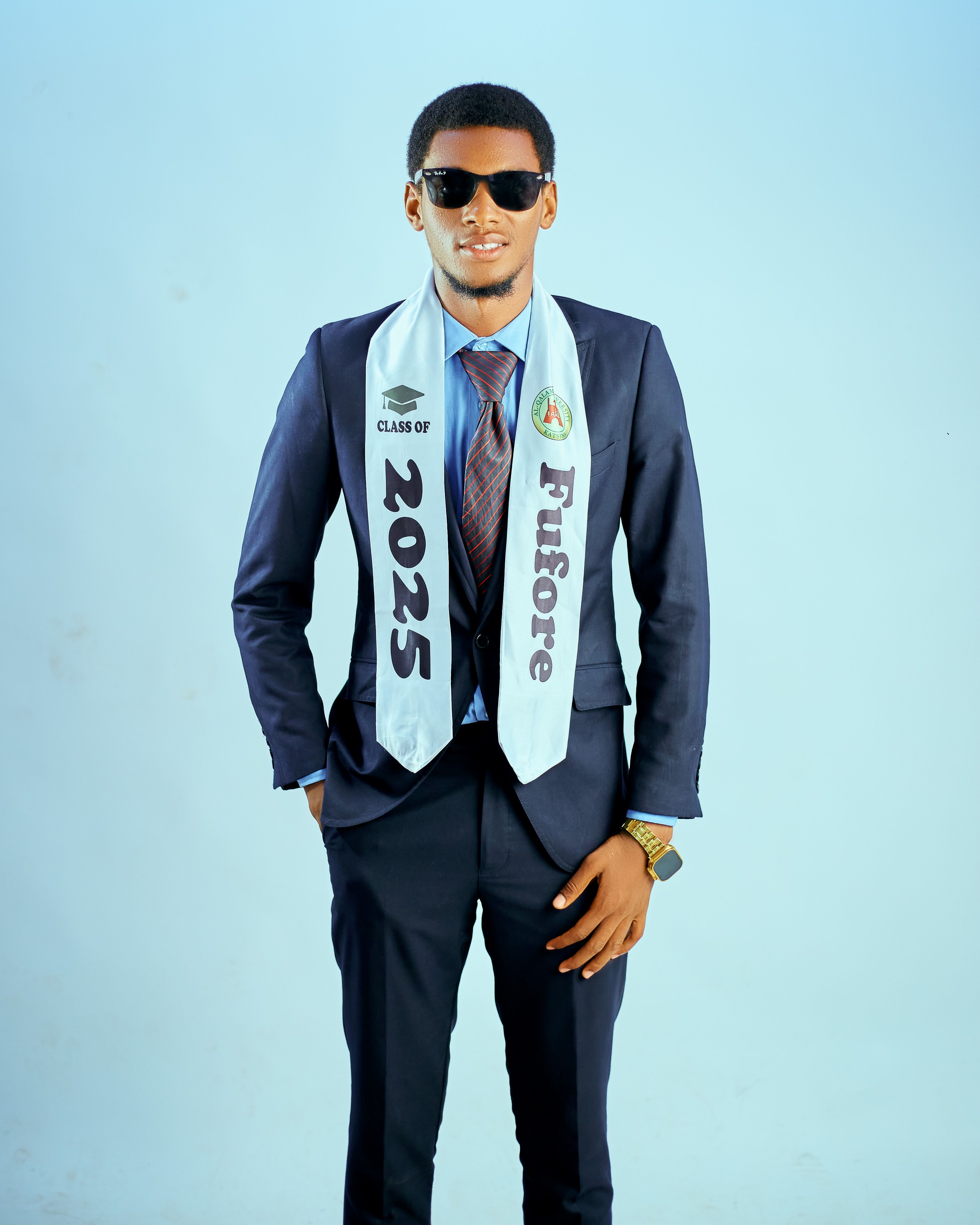 Young man in suit with graduation sash reading 'Class of 2025' and 'Fufore'.