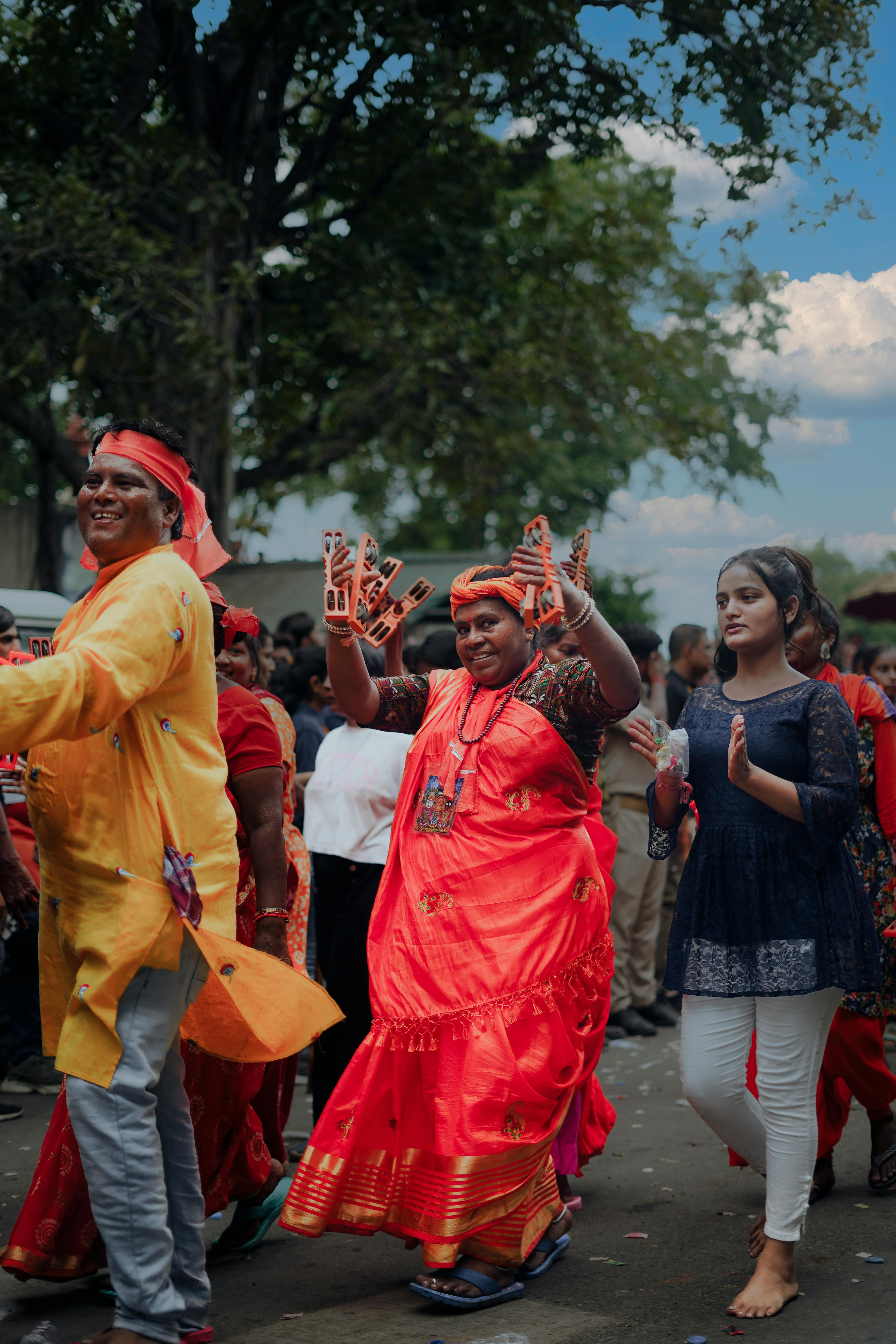 Vibrant street parade with traditional attire at Ahmedabad festival. | Indian Village Development