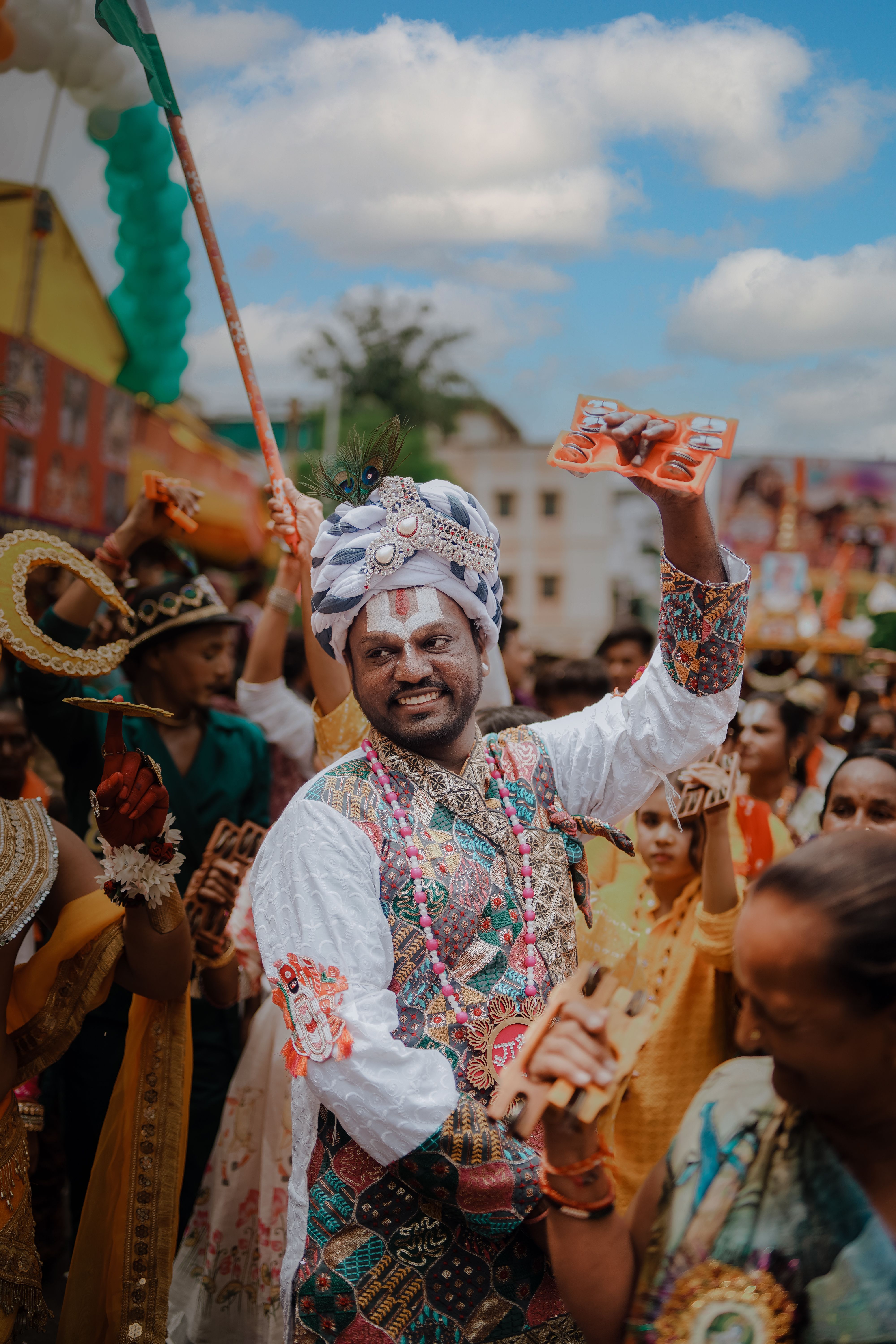 Colorful street festival in Ahmedabad, India, showcasing traditional attire and joyous celebrations. | Indian Village Development