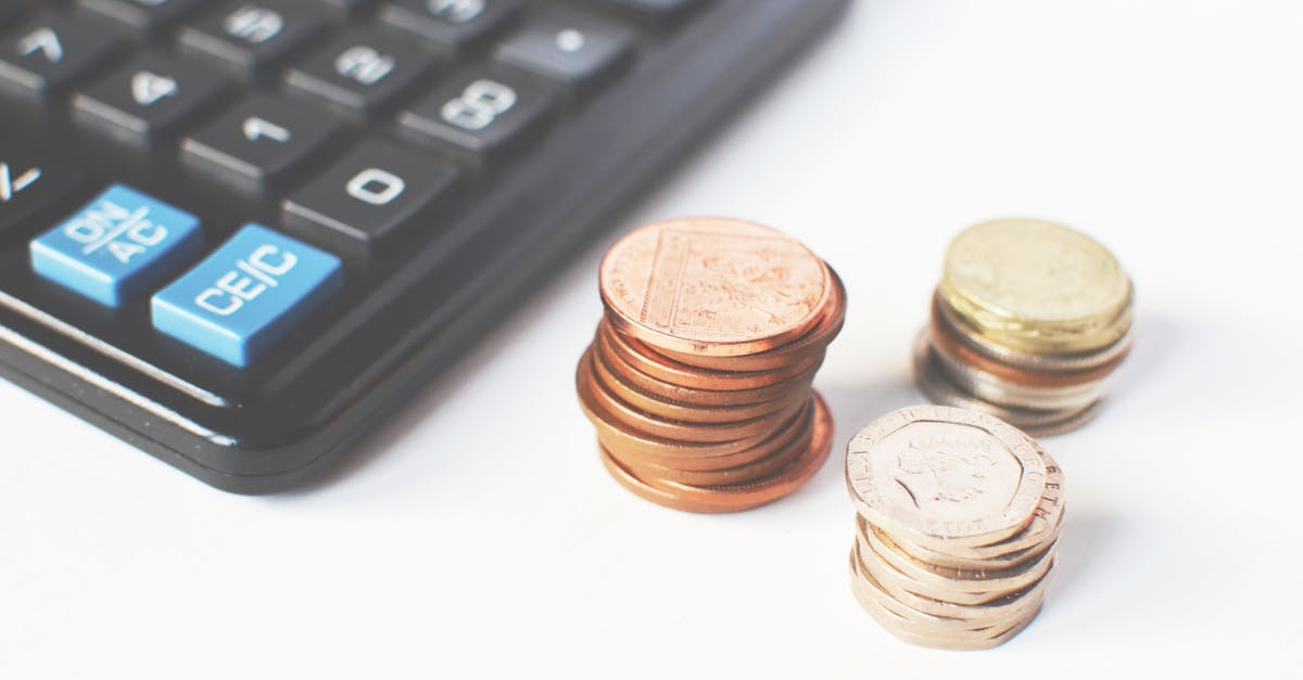 Gold-colored Coins Near Calculator