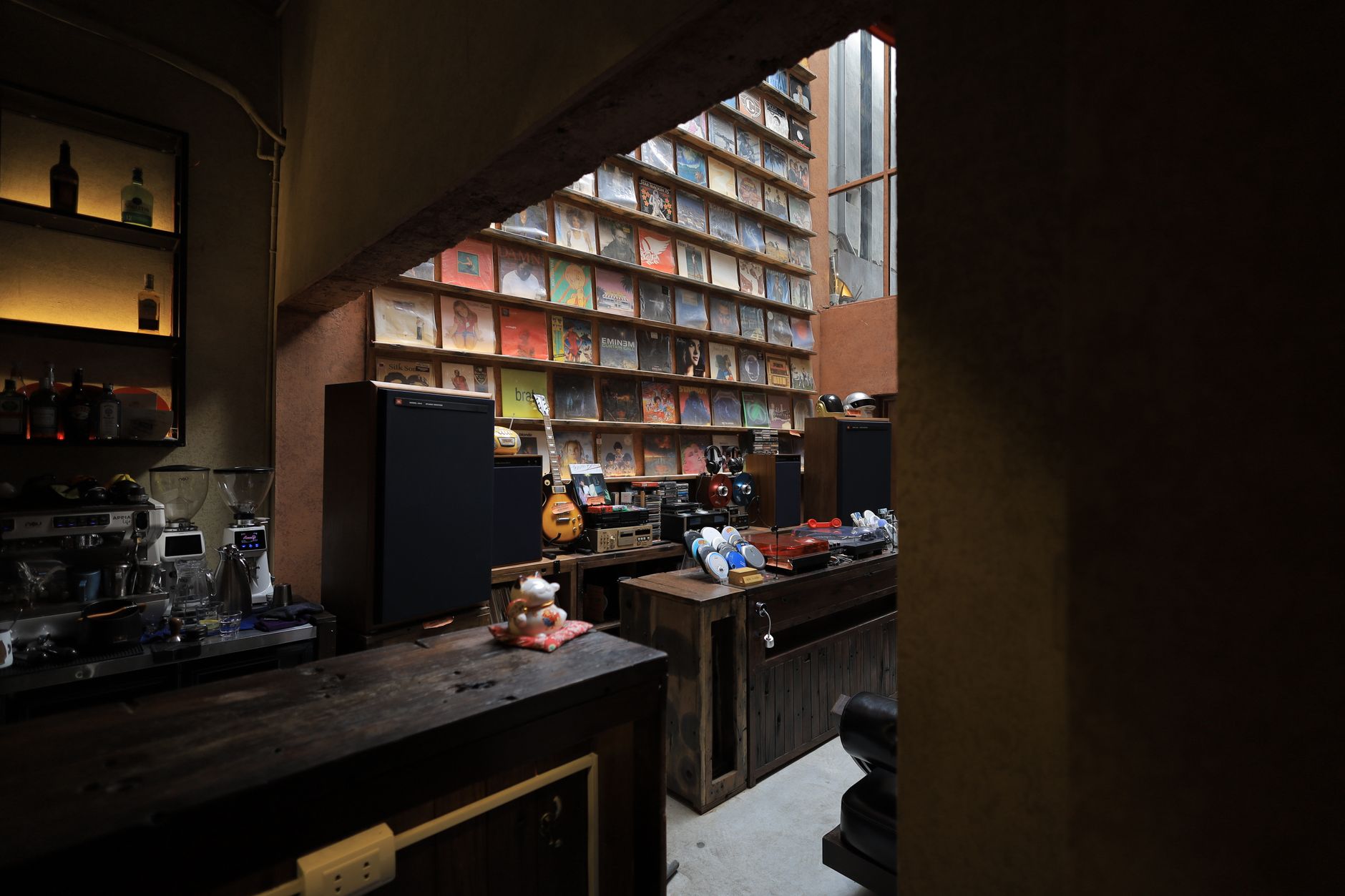 Warm interior of a cafe with vinyl records and a bar area in Vietnam.