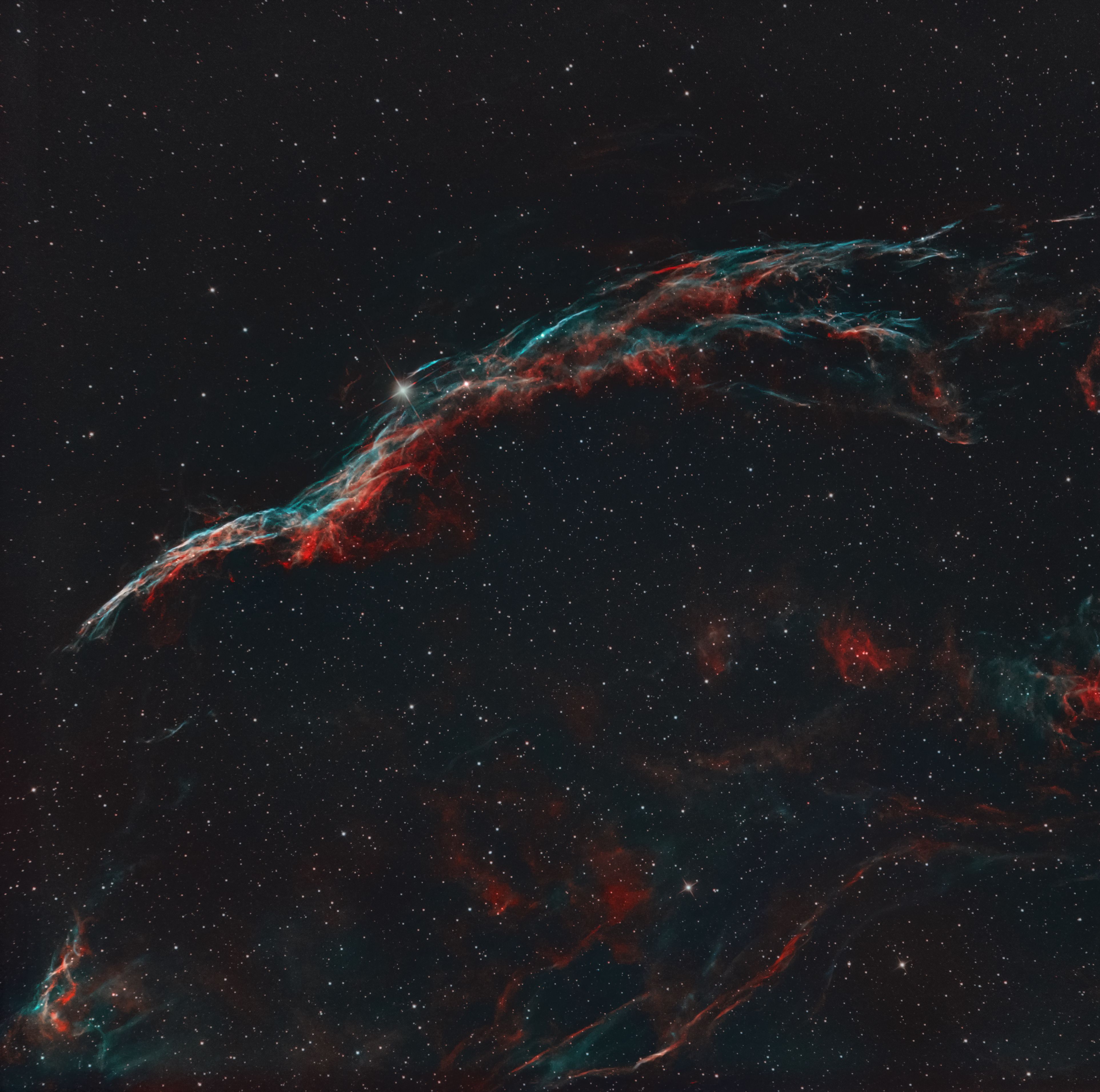 A captivating long-exposure photo of the Veil Nebula showcasing its vibrant colors and structure.