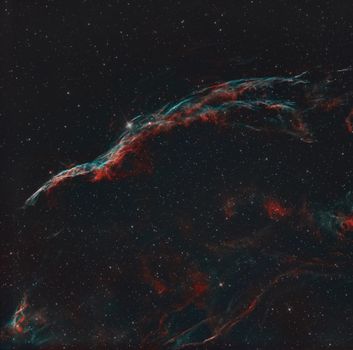 A captivating long-exposure photo of the Veil Nebula showcasing its vibrant colors and structure.
