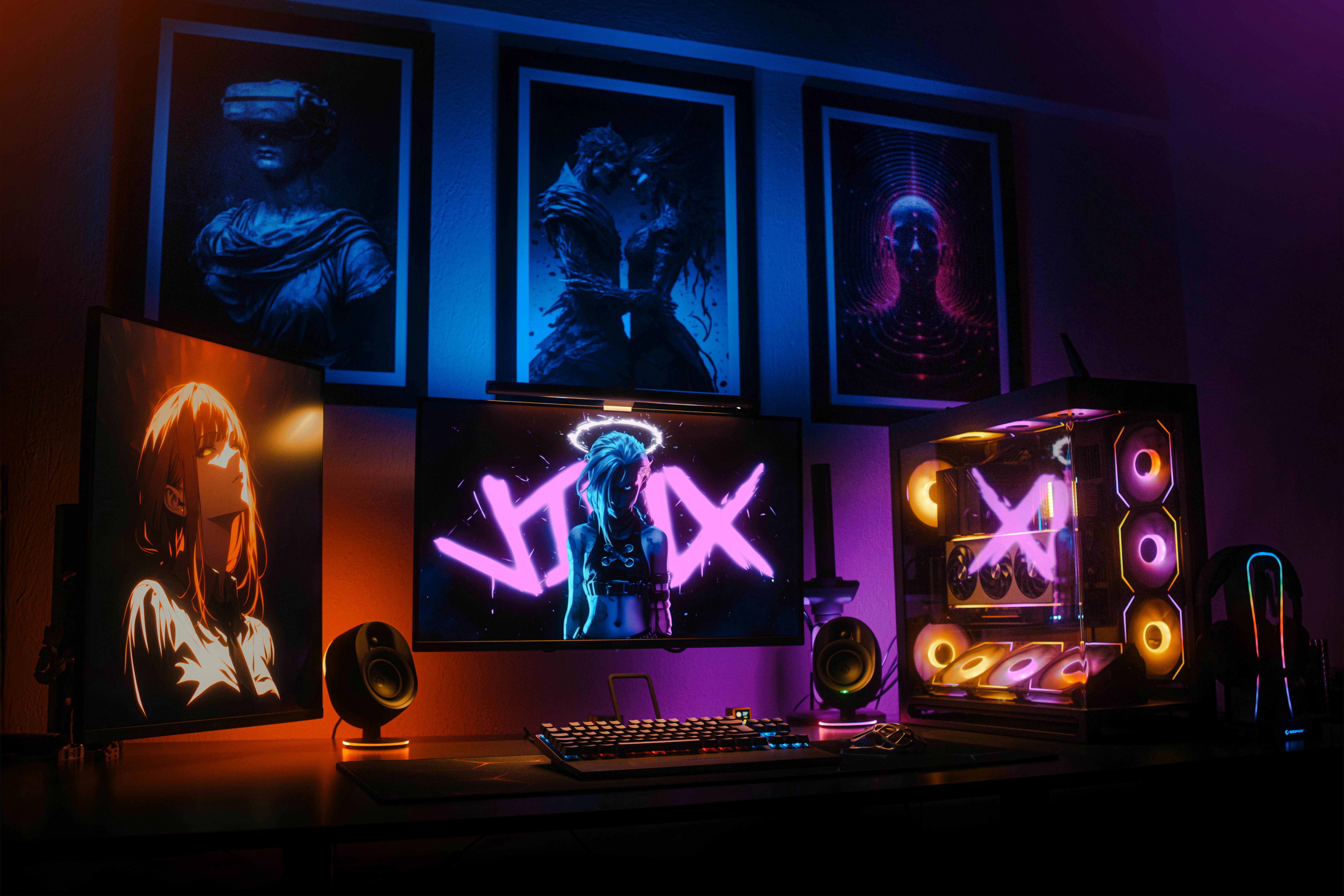 Modern gaming setup featuring neon lights, multiple screens, and art deco posters, perfect for tech enthusiasts.