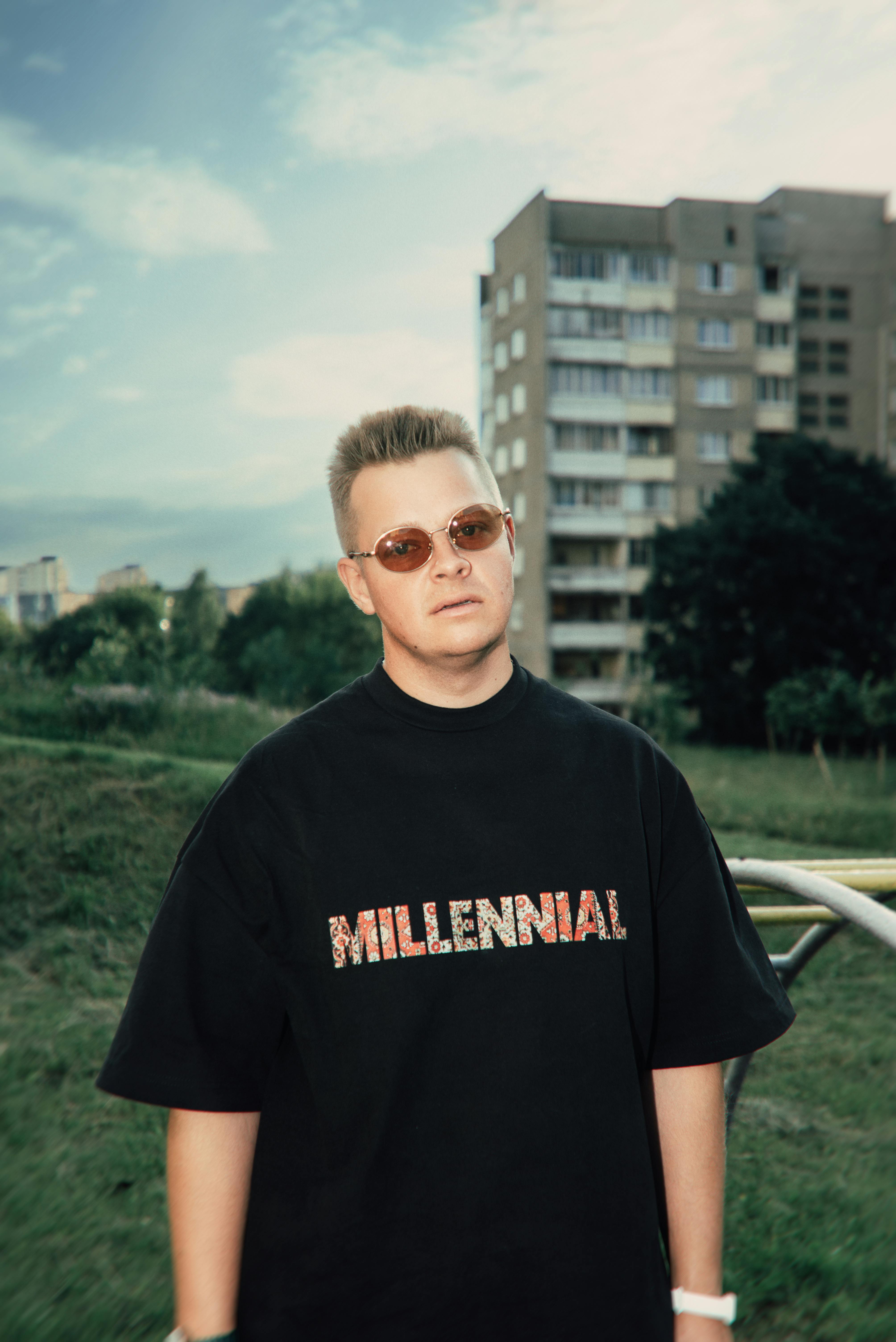 Trendy individual with sunglasses in a cityscape showcasing urban fashion.