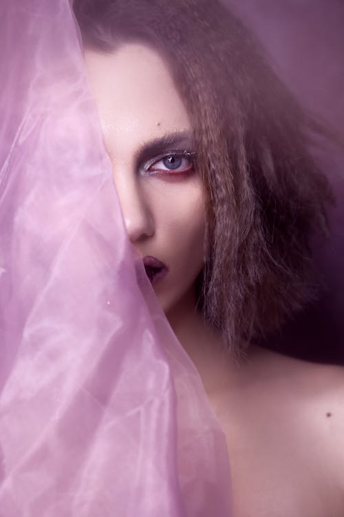 Close-Up Photo of Woman Holding Purple Sheer Fabric