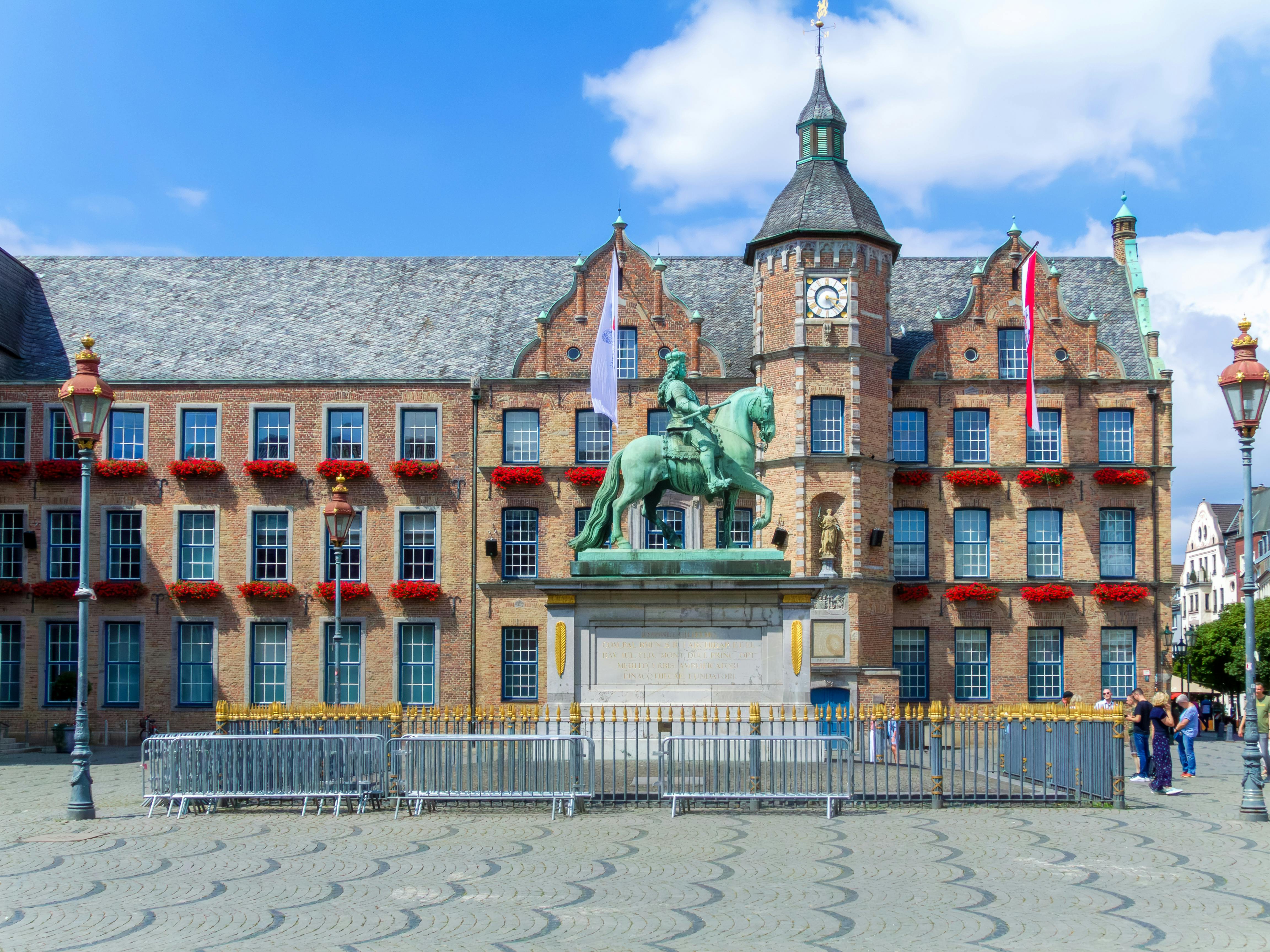 Historic Düsseldorf Marktplatz featuring Wilhelm II statue and Rathaus building in North Rhine-Westphalia, Germany.