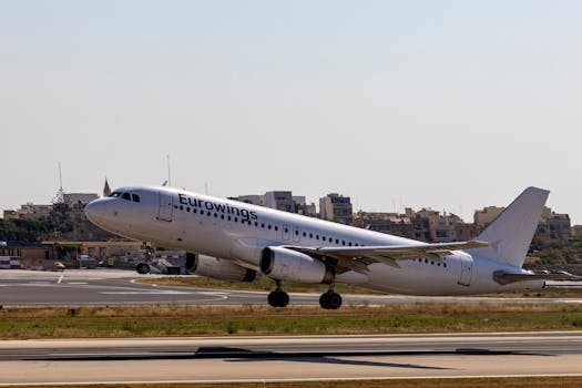 Eurowings commercial airplane lifting off from runway on a clear day.