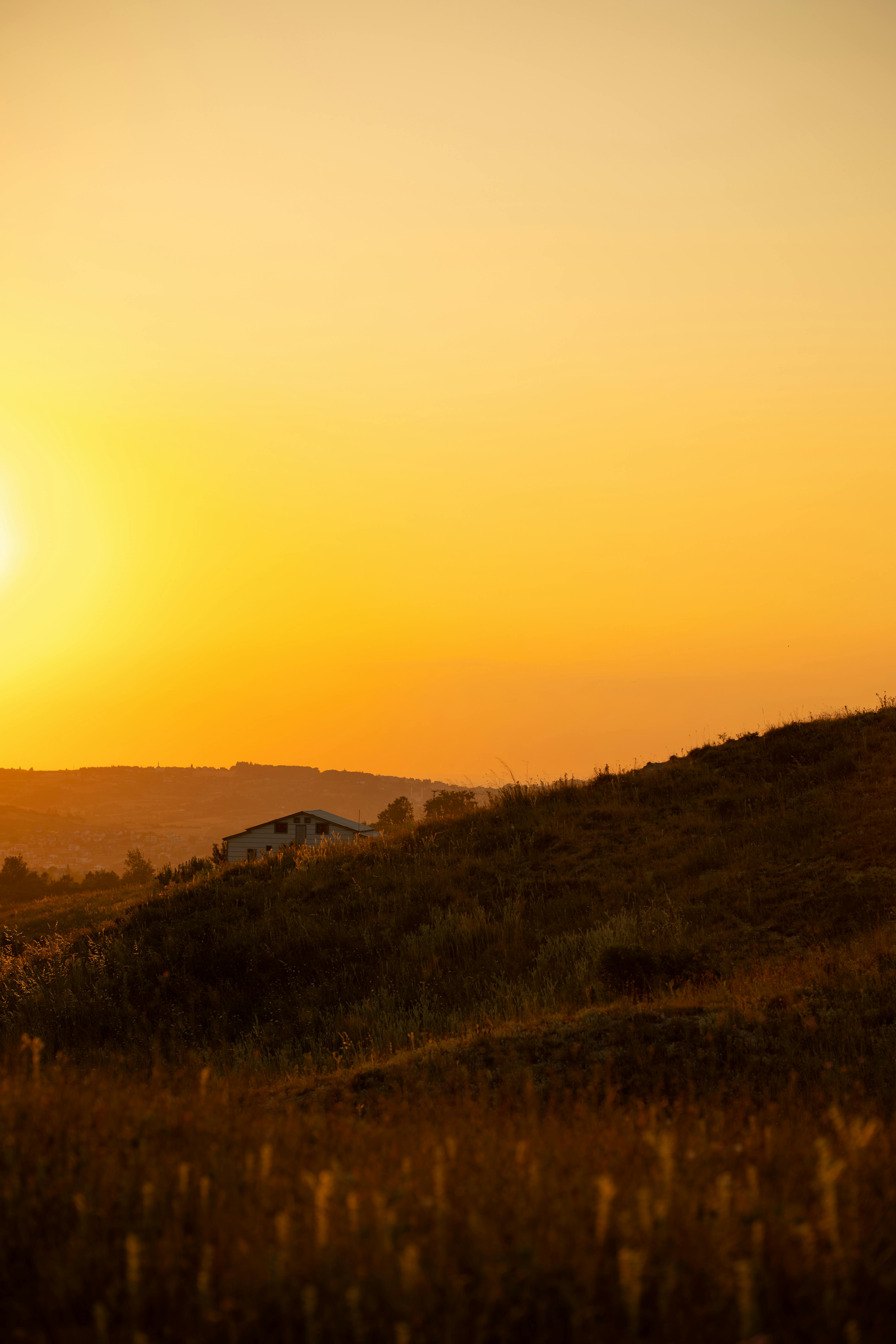 Captivating sunset view over Yalova hillside with warm golden hues and peaceful ambiance.