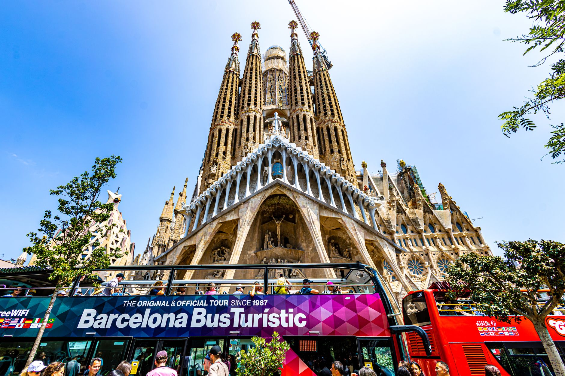 Vibrant scene of tourists at Sagrada Familia in Barcelona, Spain.