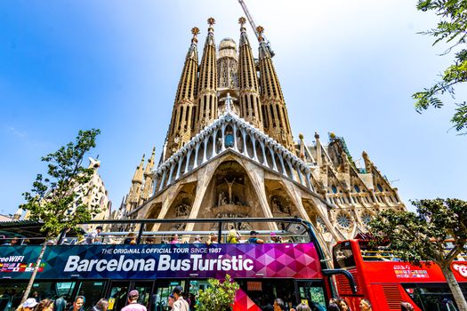Vibrant scene of tourists at Sagrada Familia in Barcelona, Spain.