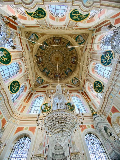 Free Ornate mosque ceiling with intricate designs and chandeliers. Stock Photo