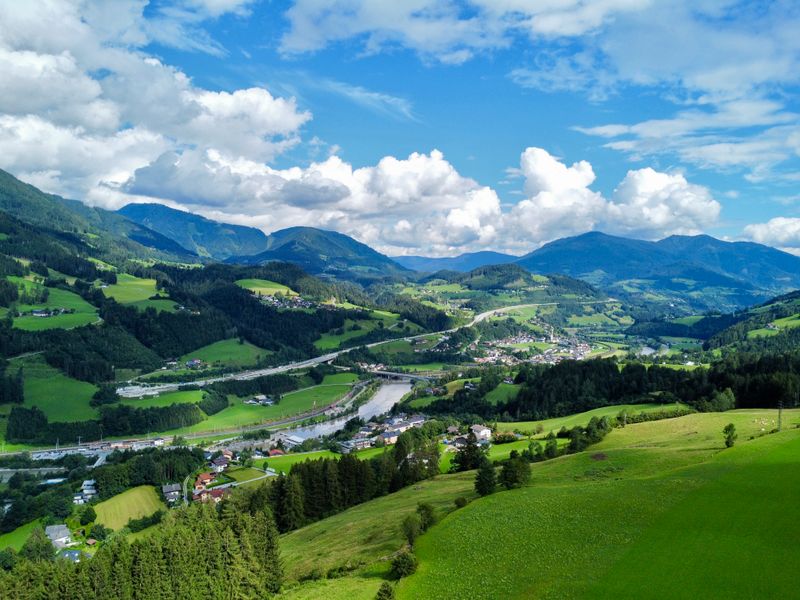 An alpine valley with scattered settlements below — photo by Joonseok Park on Pexels