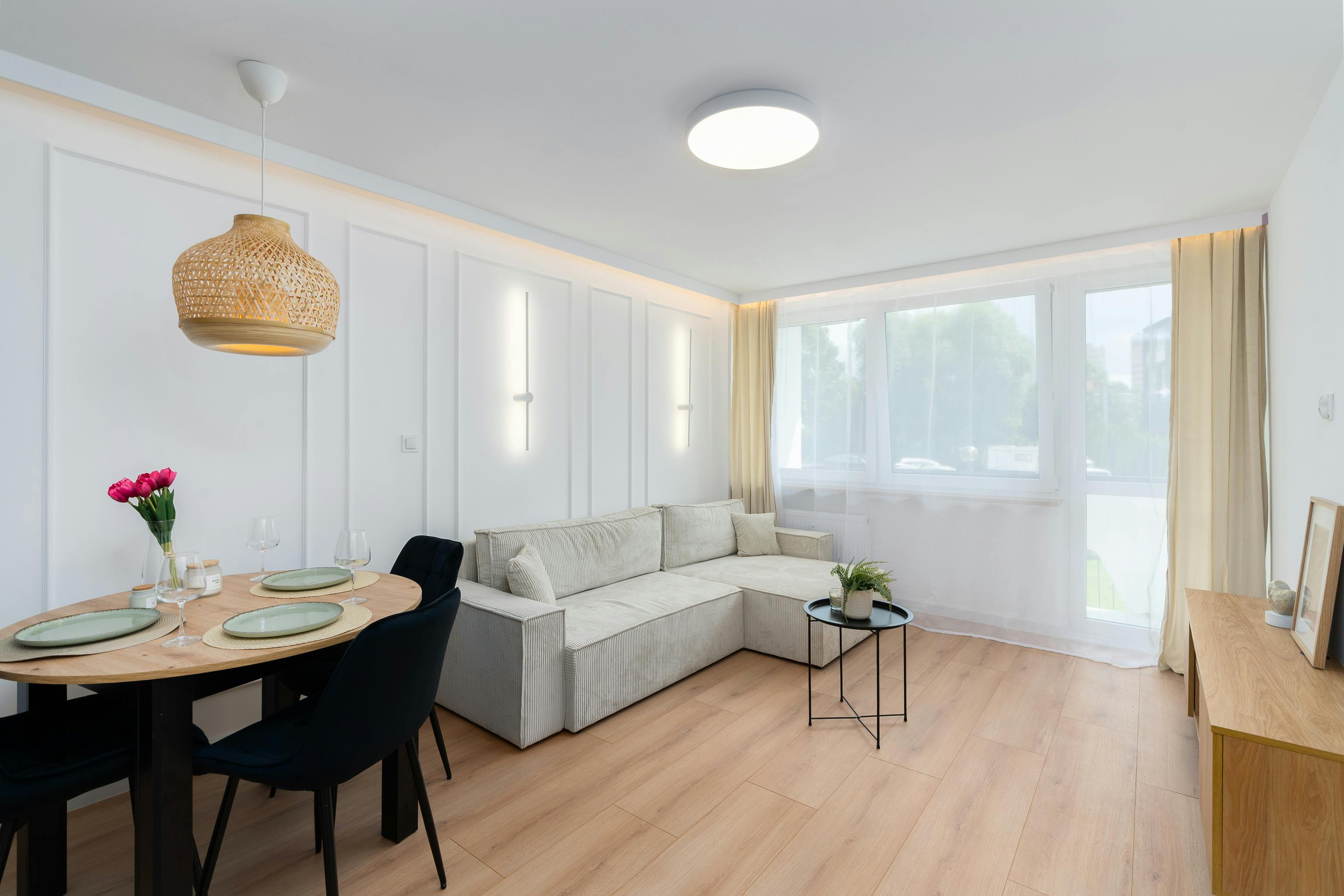 Skandinavischer Essbereich mit linearer Pendelleuchte über einem Holztable, warmes Licht in 70 cm Höhe