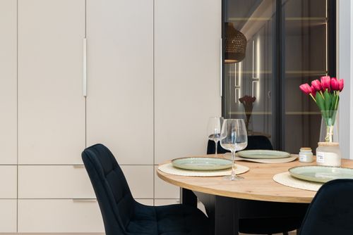 Free Stylish Kraków dining room with elegant tableware and decor enhancing modern design. Stock Photo