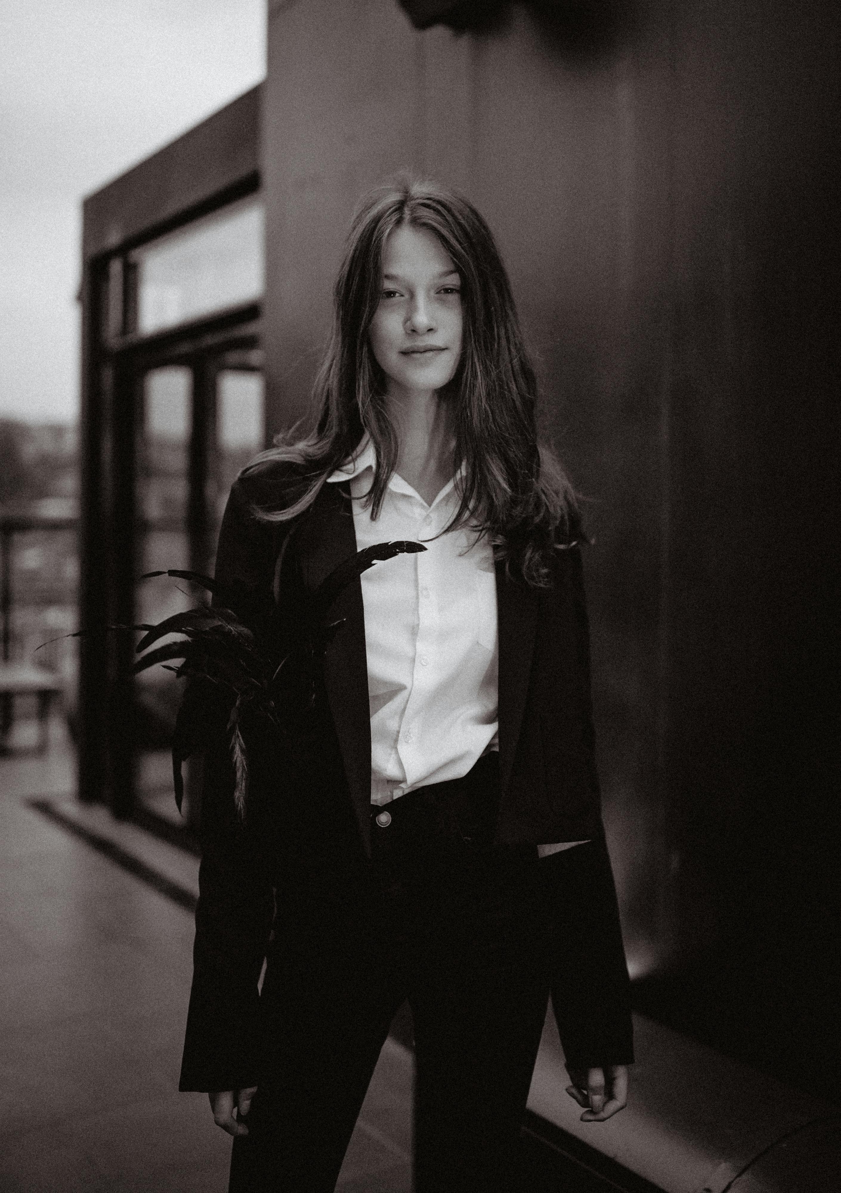 Free Elegant black and white portrait of a young woman in a stylish outfit, exuding a classic and timeless aura. Stock Photo