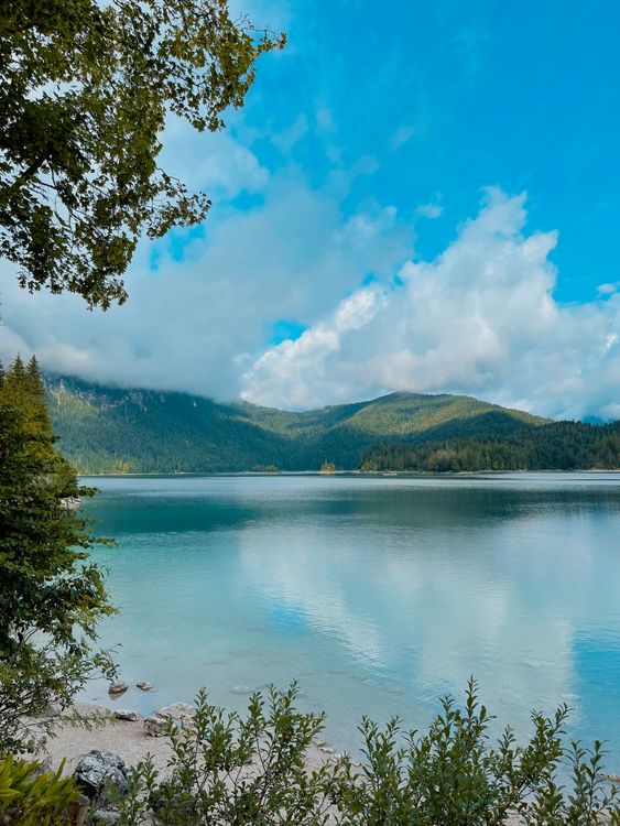 Tranquil Mountain Lake Under Bright Blue Sky · Free Stock Photo