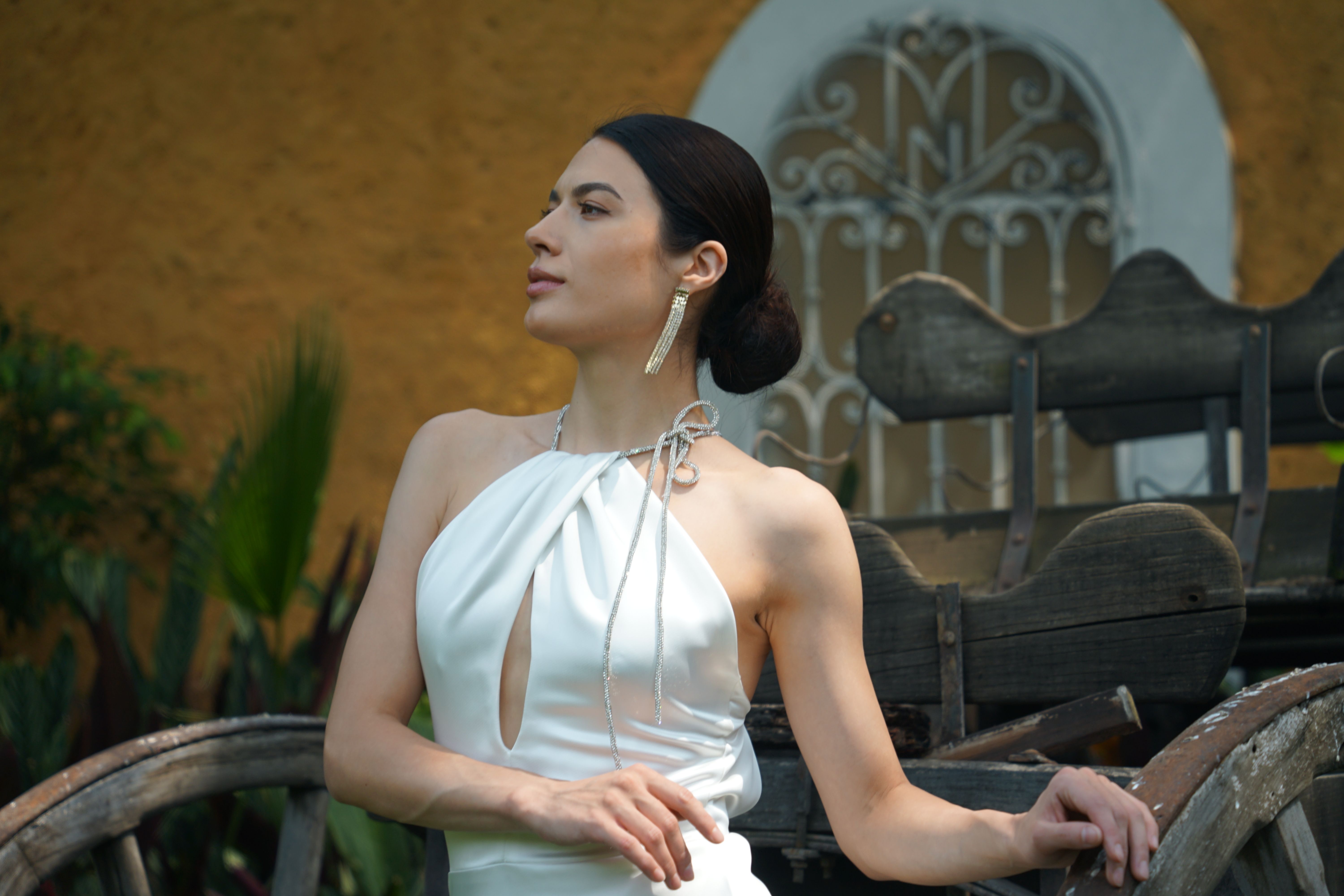 Elegant woman posing in white dress outdoors · Free Stock Photo