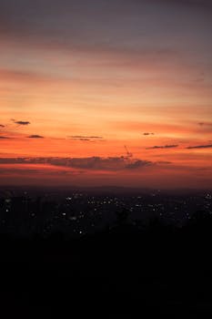 City skyline at sunset with warm, colorful skies creating a dramatic cityscape view.
