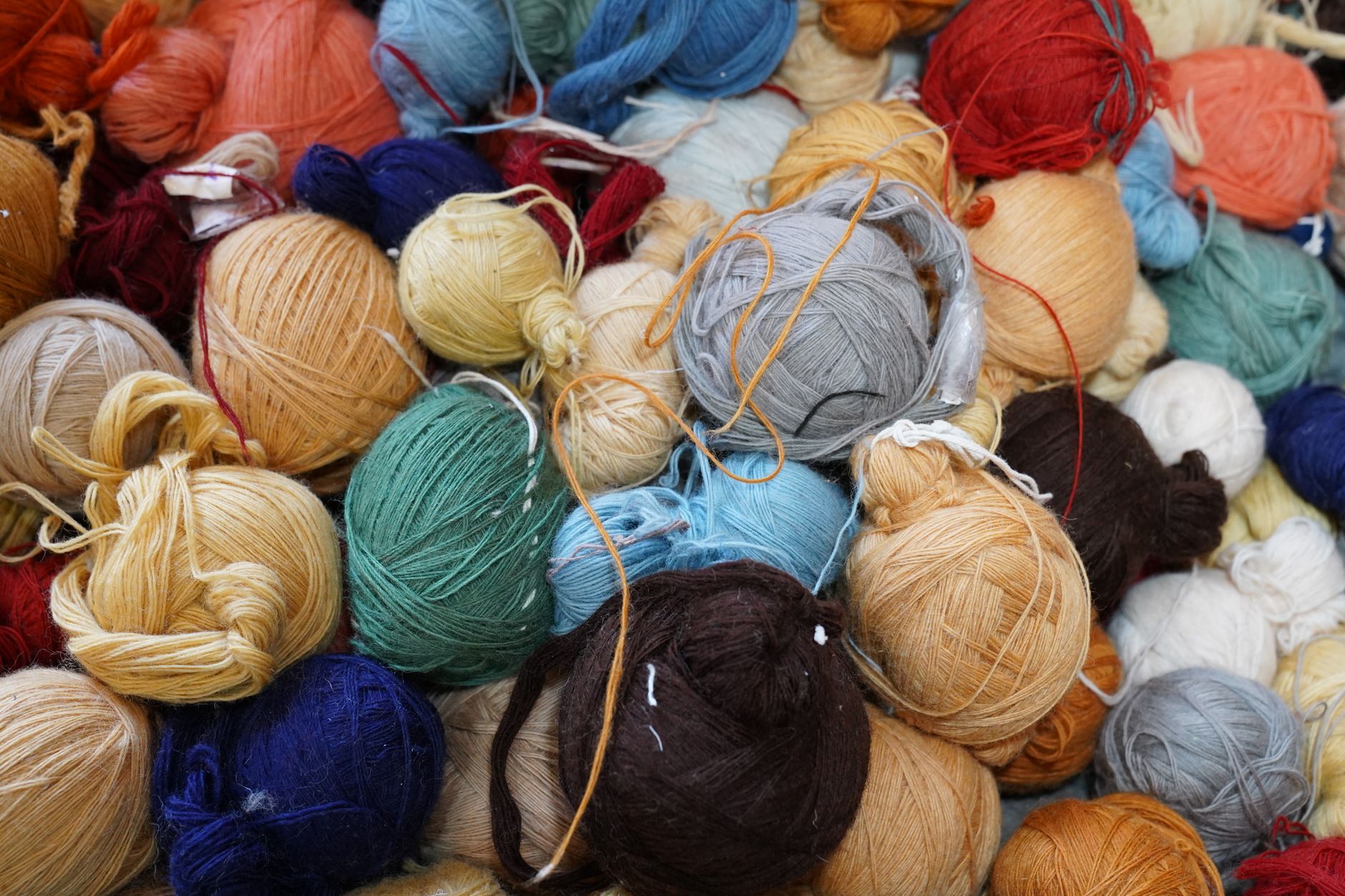 A diverse collection of colorful yarn balls showcasing various textures and hues, ideal for knitting and crafts.