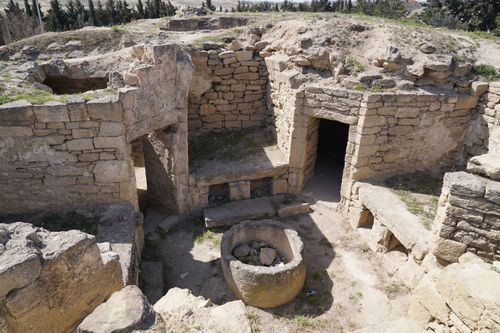 Free Explore these ancient stone ruins with a mysterious circular structure under the bright daylight. Stock Photo