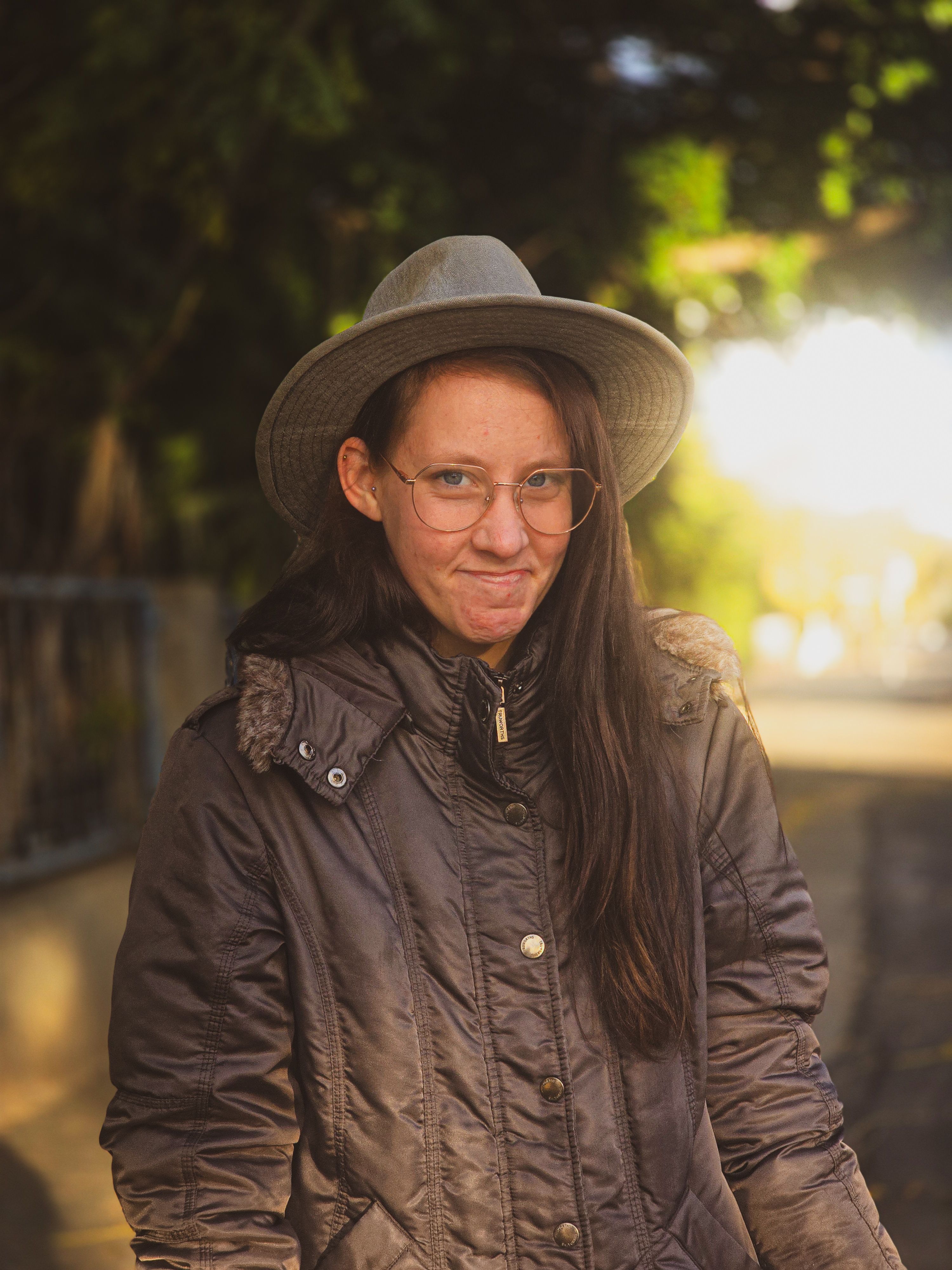 Captivating portrait of a woman in Oudtshoorn, showcasing a warm and serene moment outdoors.