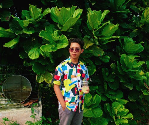 Photo Of Man Standing Beside Plants