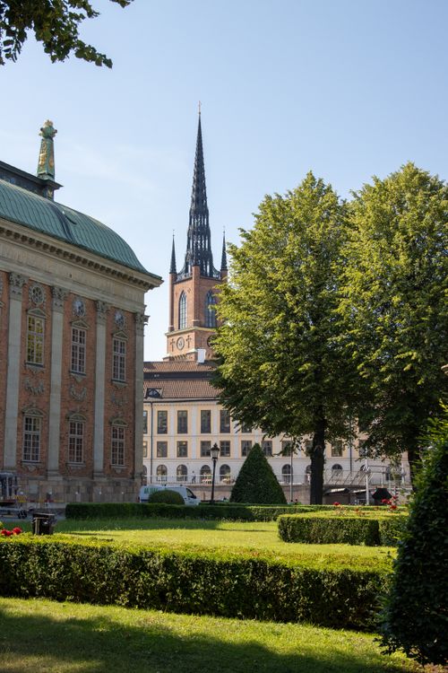 Free Elegant view of Riddarholmen Church with lush greenery in Stockholm, Sweden. Stock Photo