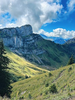 Experience the breathtaking Alpine landscape in Haute-Savoie, France, with lush greenery and dramatic mountains.