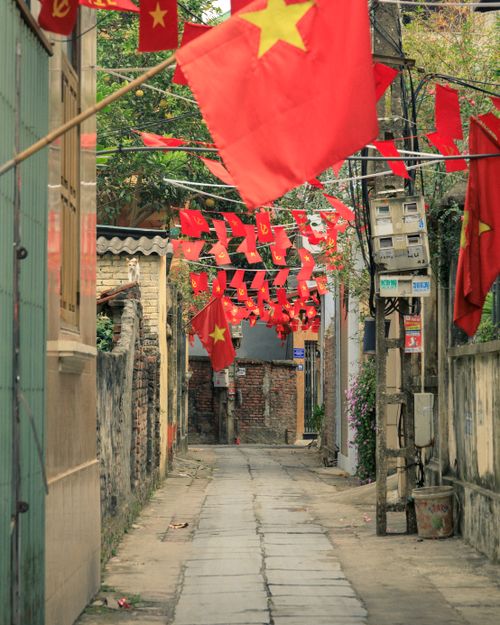 Free Charming alley in Bắc Ninh, Vietnam, festooned with vibrant red flags. Stock Photo