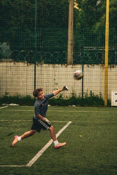 A young goalkeeper makes a dynamic save during a football match in Kyiv, Ukraine.