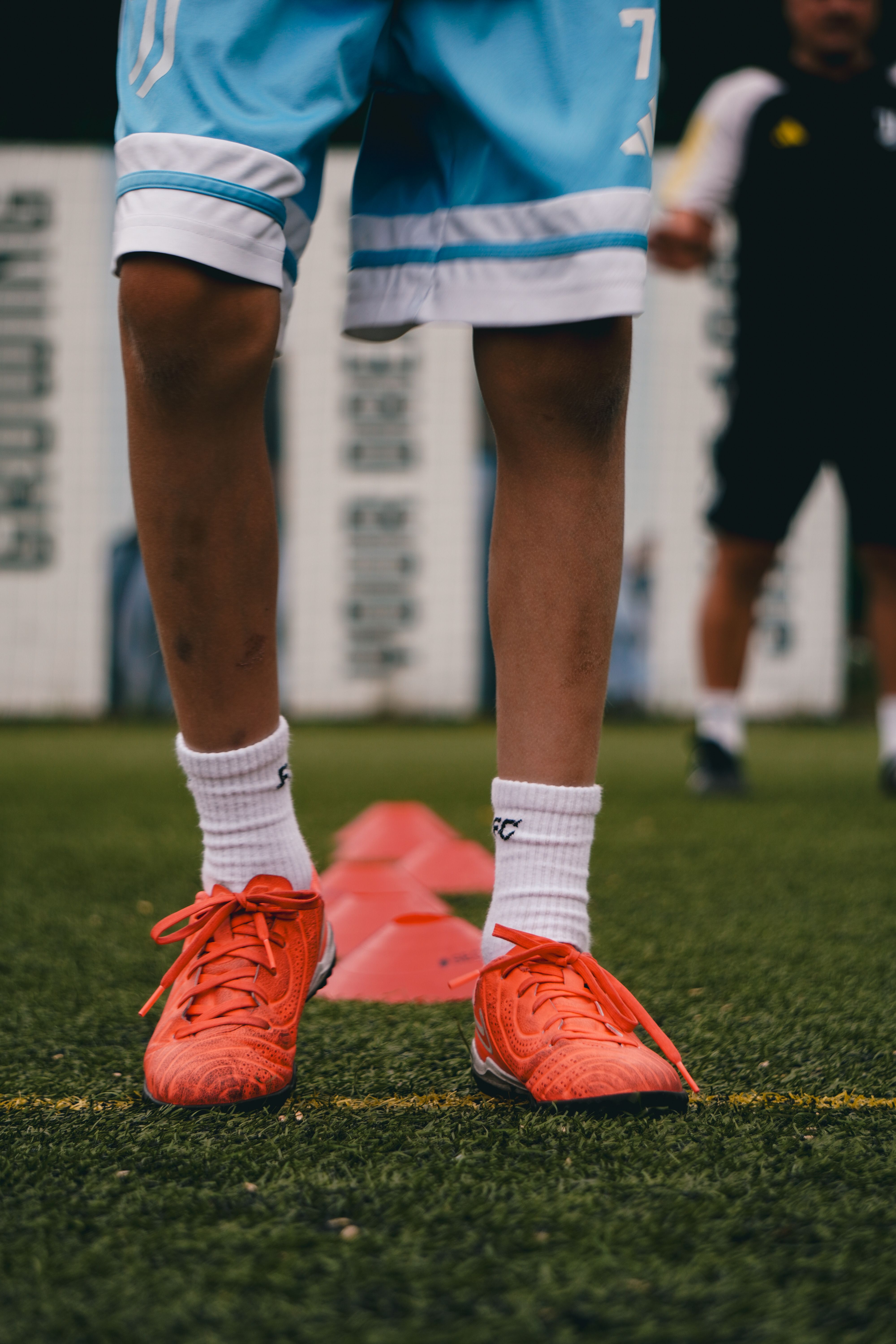 A focused young athlete performing drills to improve athletic skill building