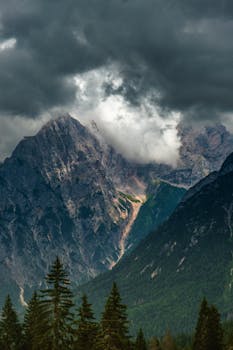 Majestic mountain peaks under dramatic storm clouds, perfect for nature lovers.